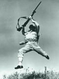 Soldier Jumping With Rifle  Low Angle View