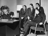 Men Looking at Group in Meeting