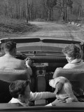 Family Driving in Convertible Along Country Road