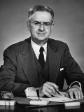 Man Sitting at Desk  Holding Pen