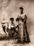 Boy (4-6) on Tricycle With Mother