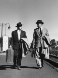 Two Men Walking  Carrying Luggage  Briefcase and Coats