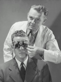 Optometrist Giving Man Eye Examination