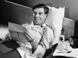 Man Lying in Bed Reading
