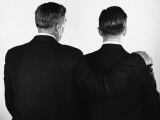 Back View of Two Men  One With Arm Around Other