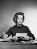 Woman Looking at Paper  Holding Pencil