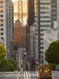 Cable Car Crossing California Street With Bay Bridge Backdrop in San Francisco  California  USA