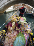 Couple at the Annual Carnival Festival Enjoy Gondola Ride  Venice  Italy