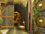Oak Barrels Stacked Outside of Open Door To Aging Caves at Ironstone Winery  California  USA