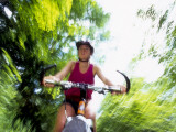 Young Female Recreational Mountain Biker Riding in the Forest