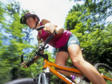 Young Female Recreational Mountain Biker Riding in the Forest