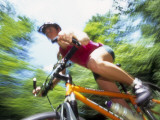 Young Female Recreational Mountain Biker Riding in the Forest