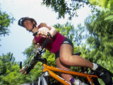 Young Female Recreational Mountain Biker Riding in the Forest
