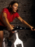 Young Woman Exercising on a Stationary Bike