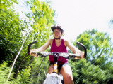 Young Female Recreational Mountain Biker Riding in the Forest