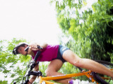 Young Female Recreational Mountain Biker Riding in the Forest