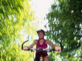 Young Female Recreational Mountain Biker Riding in the Forest