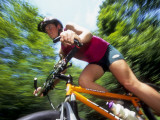 Young Female Recreational Mountain Biker Riding in the Forest