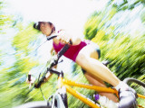 Young Female Recreational Mountain Biker Riding in the Forest
