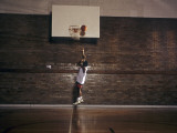 Young Boy Practicing his Basketball Shooting