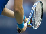 Detail of Tennis Player Holding the Racquet and Ball About to Serve
