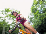 Young Female Recreational Mountain Biker Riding in the Forest