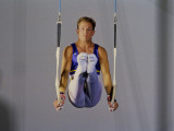 Male Gymnast Performing on the Rings