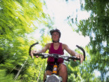 Young Female Recreational Mountain Biker Riding in the Forest