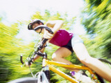 Young Female Recreational Mountain Biker Riding in the Forest