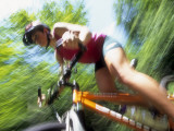 Young Female Recreational Mountain Biker Riding in the Forest