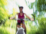 Young Female Recreational Mountain Biker Riding in the Forest