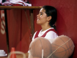 High School Girls Basketball Player Resting During Practice Session