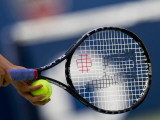 Detail of Tennis Player Holding the Racquet and Ball About to Serve