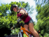 Young Female Recreational Mountain Biker Riding in the Forest