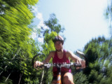 Young Female Recreational Mountain Biker Riding in the Forest