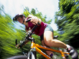 Young Female Recreational Mountain Biker Riding in the Forest