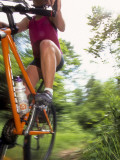 Young Female Recreational Mountain Biker Riding in the Forest