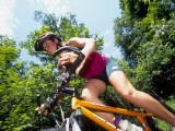 Young Female Recreational Mountain Biker Riding in the Forest