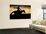 A Silhouetted Cowboy Riding Alone a Ridge at Sunset in Shell  Wyoming  USA