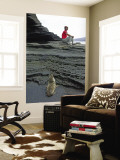 Sea Lion Cub Watching Visitor on Eroded Lava Rocks at Puerto Egas