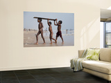 Three Boys Carrying Wooden Plank from Ocean