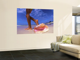 Woman Walking Past a Large Shell on the Beach