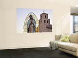 Mother Mary Sculpture with Church Belltower in Background
