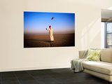Arab Handler Swinging Lure During Hunting Falcon Training Exercise in Desert