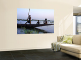 Three Boys Play on a Canoe (Pirogue) on the River in Mopti