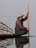 Myanmar  Inle Lake; Intha Fisherman Gently Paddling His Boat across Inle Lake  Myanmar