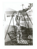 Boy with Indian Headdress on Swing Set