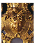 A Regence Giltwood Mirror  Detail  the Plate Surmounted by an Indian Mask with Ribbon-Tied Plumed…
