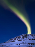 An Aurora Borealis Shooting Up from Toviktinden Mountain  Norway