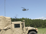 A UH-1N Helicopter Flies over the Marine Air Support Squadron Compound